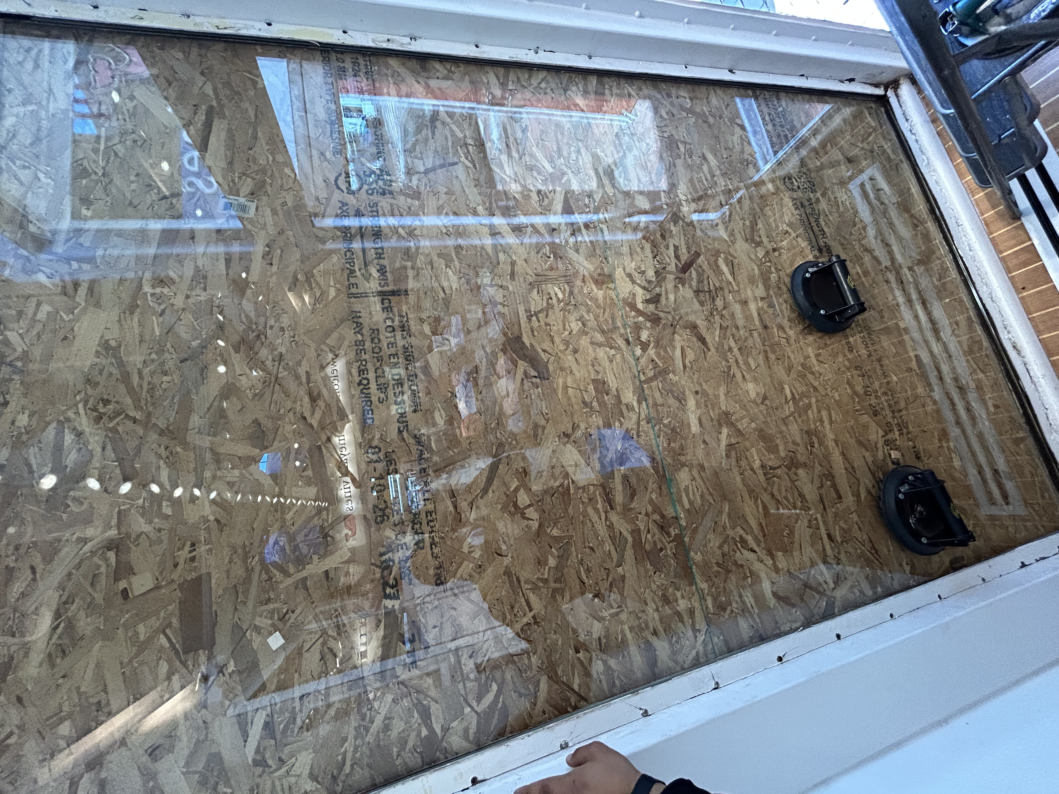 Completed professional board-up securing a commercial storefront